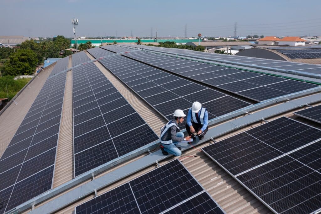 Two men working on industrial solar panels